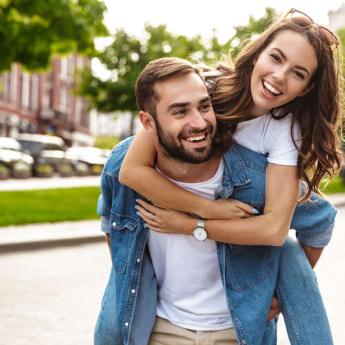 beautiful-young-couple-love-walking-outdoors-city-street-piggyback-ride2